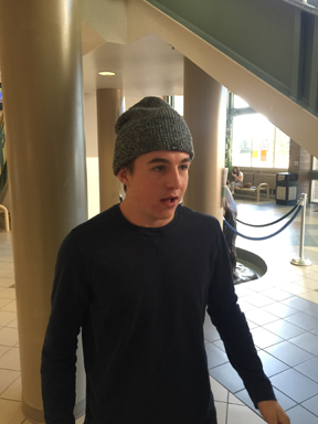 Grant OShea walks through the lobby of RV wearing his ski hat.