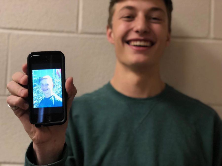 Junior Jack Howard poses for a photo, showcasing a picture of himself as a young child so that he and everyone else sees how far hes come in his high school career.